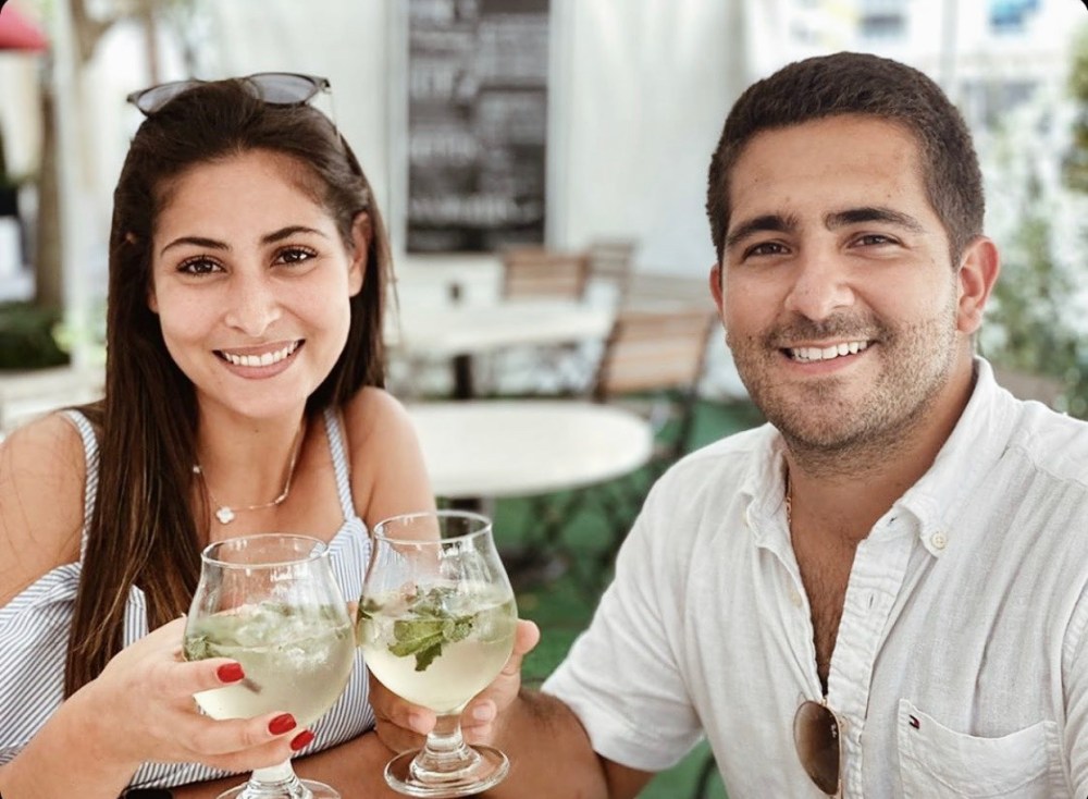 a couple doing cheers with their cocktails