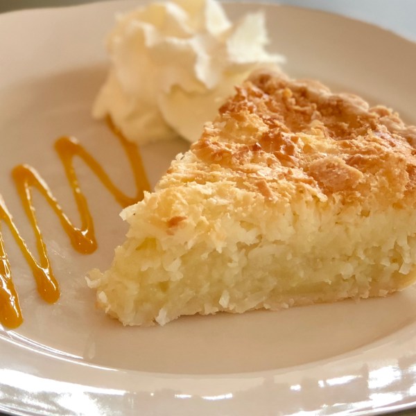 a slice of coconut quiche pie with whipped cream