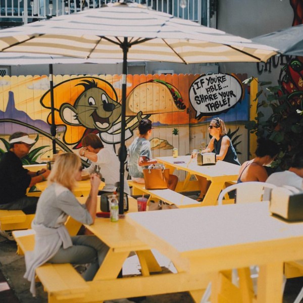 outdoor dining at a taco shop with yellow tables in west palm beach