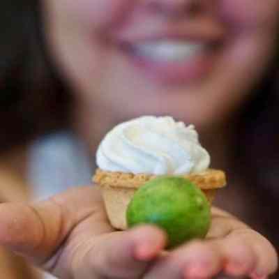 woman holding piece of food