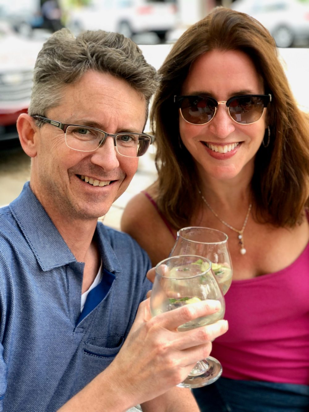 a man and woman holding wine glasses