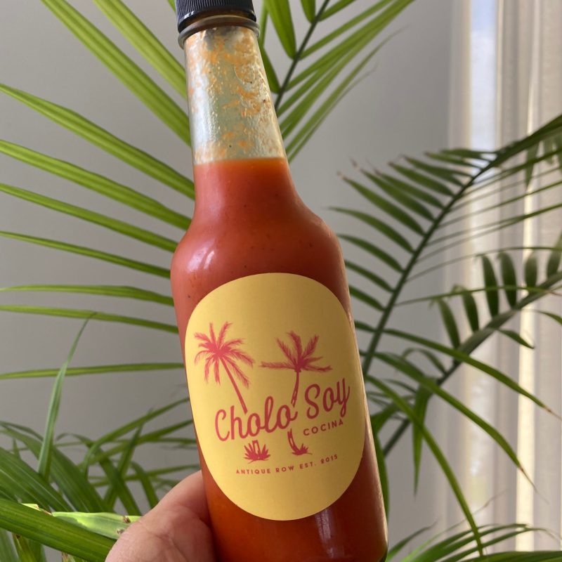 hot sauce bottle with a palm tree in the background