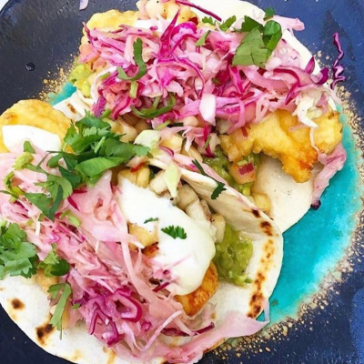 a pizza sitting on top of a plate of food