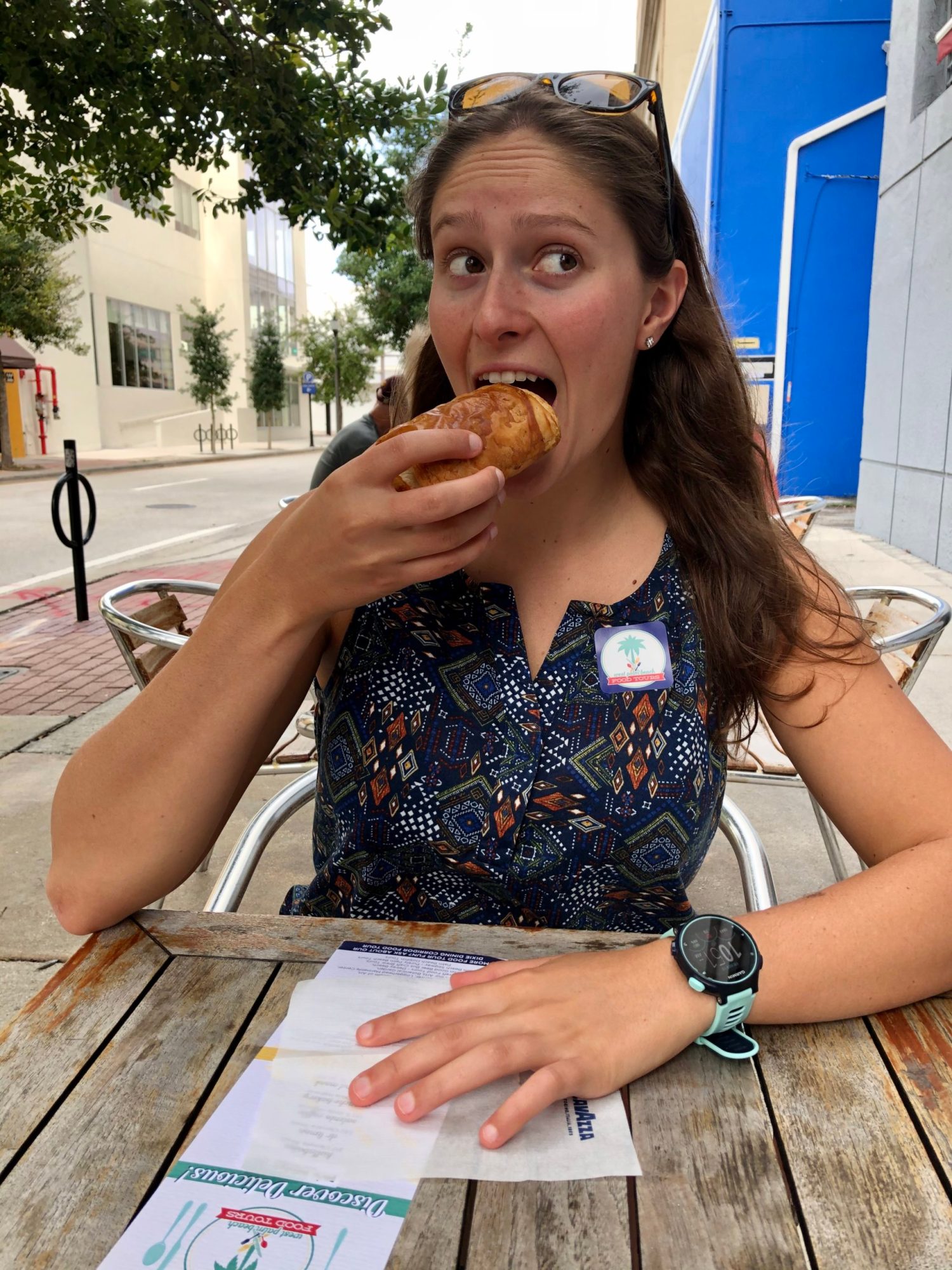 girl eating croissant on the downtown west palm beach food tour