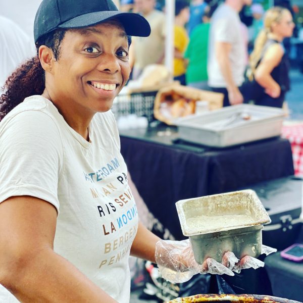 a lady making conch fritters at the west palm beach greenmarket
