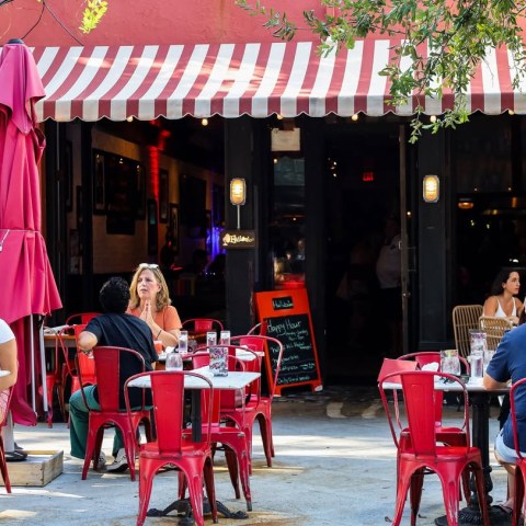 a group of people sitting in front of a store