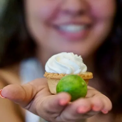 a woman holding a piece of fruit