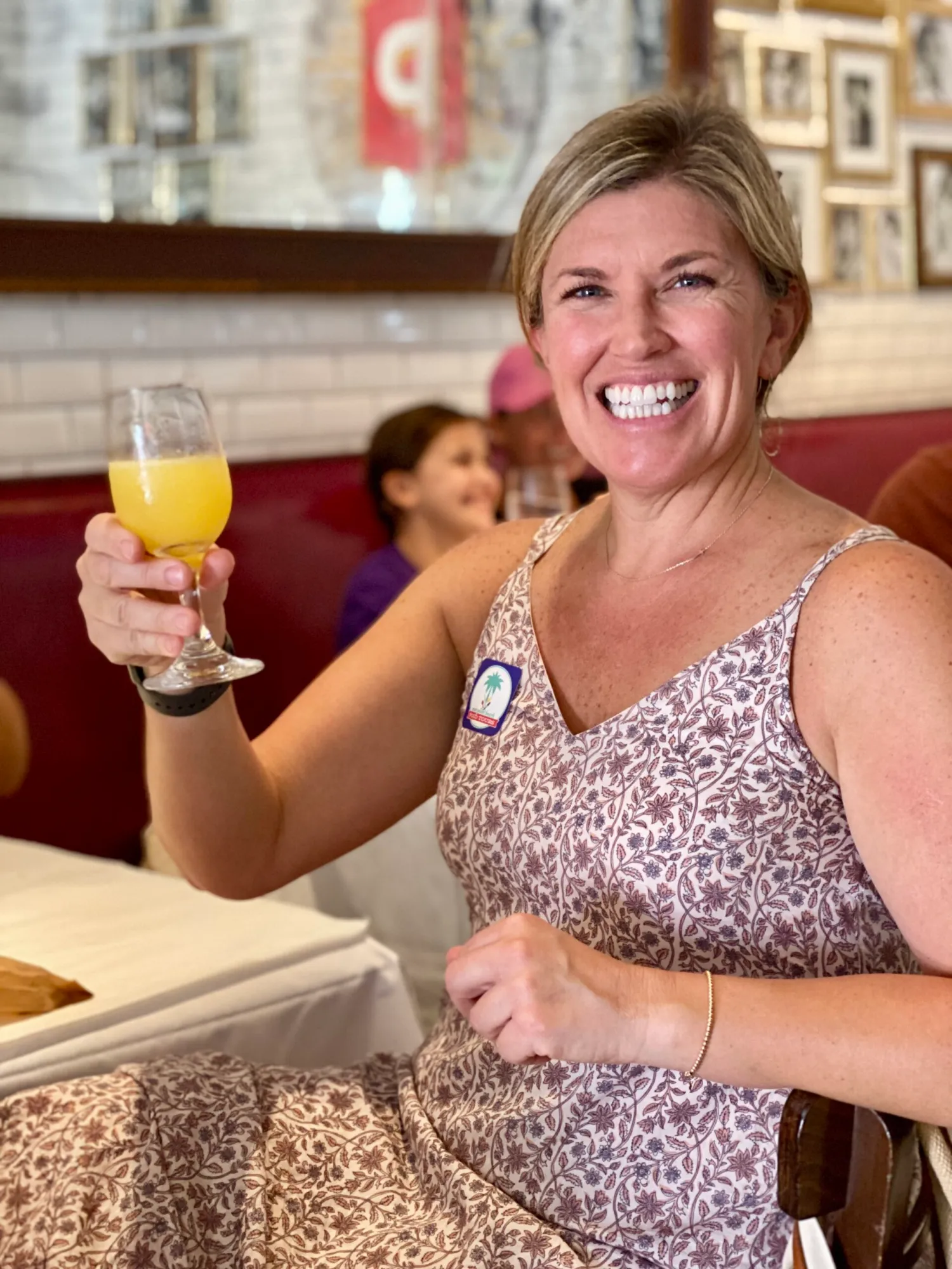 IMG_1691 a woman sitting at a table with a mimosa
