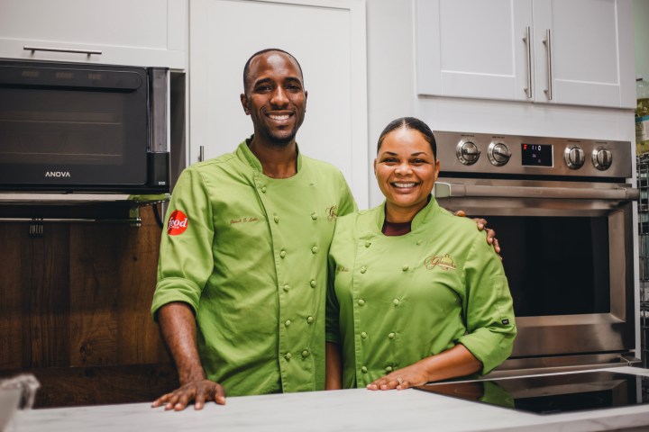 a man and a woman standing in a kitchen