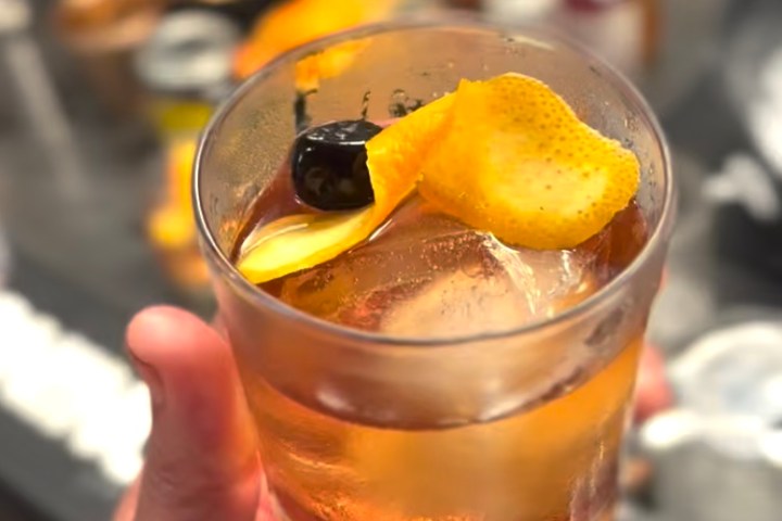 a hand holding a cocktail