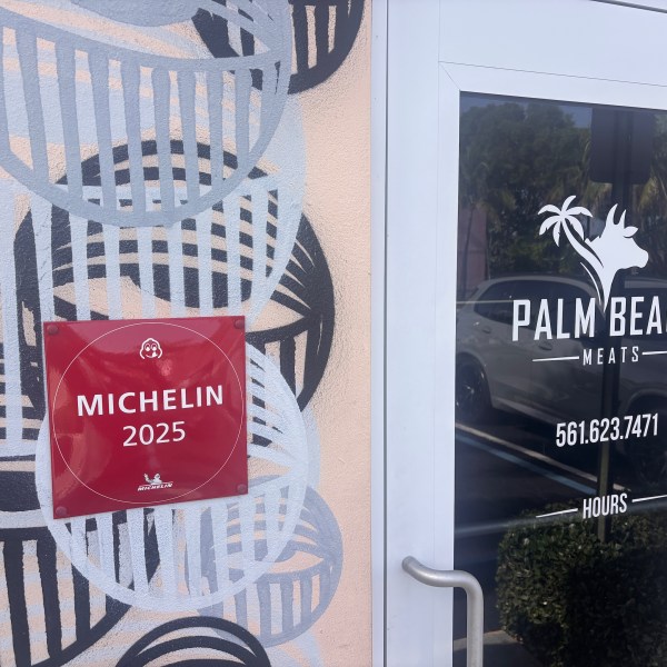 Door with Palm Beach Meats logo and Michelin 2025 sign nearby.